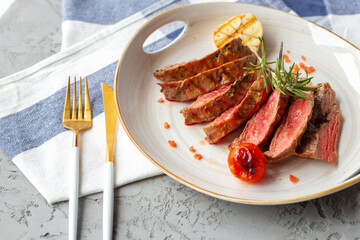Sliced medium rare grilled steak on plate
