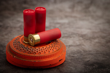 Clay shooting target and shotgun bullets on texture background ,Clay Pigeon target game - obrazy, fototapety, plakaty
