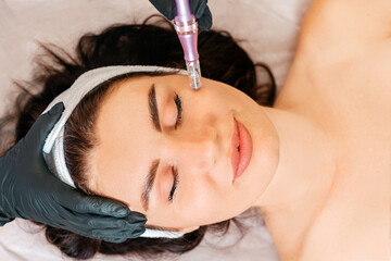 Professional skin care. Beauty treatment of fractional mesotherapy of woman's face. Top view....