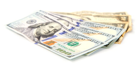 several large and small dollar bills fanned out isolated on white background