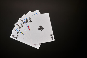 Straight flush - playing cards on dark background