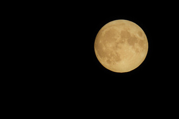 Bright full moon on dark night sky. Seen from Western Canada.