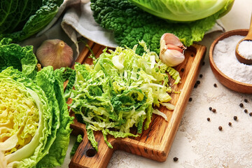 Heap of cut savoy cabbage on light background, closeup