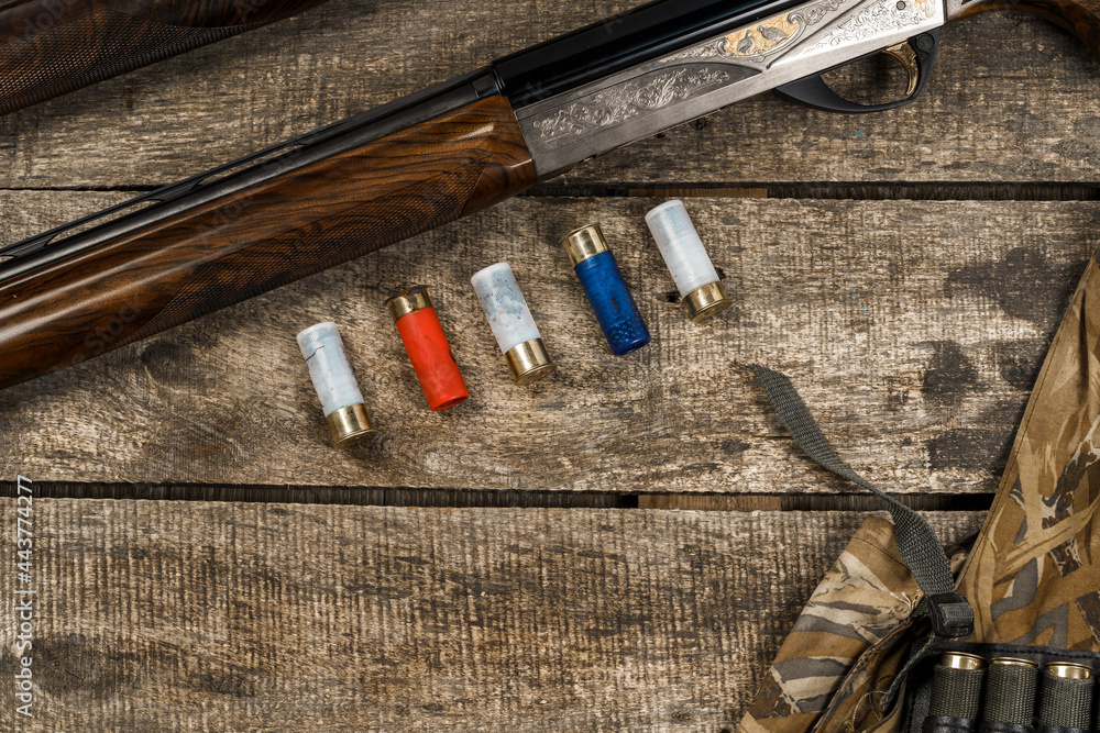 Wall mural Various hunting equipment on old wooden background