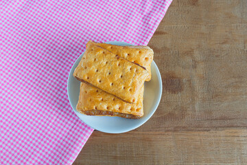 Traditional pineapple jam in roll pies on tablecloth.