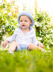 Kid outdoor with panama. Walking in summer casual clothes. Happy smiling child in spring park or...