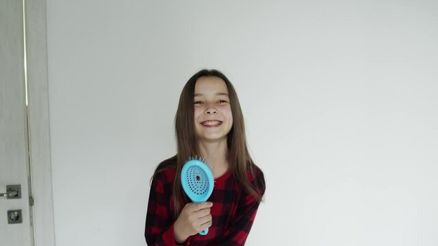 Girl in the studio, sings and smiles while dancing