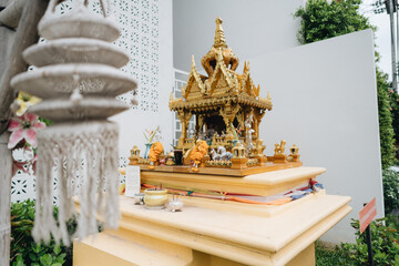 The small spirit house with flowers and other decorative stuff in Chiang Mai