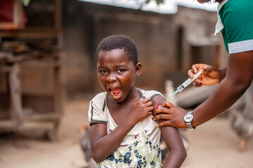 image of african girl screaming, health official injecting african kid- 