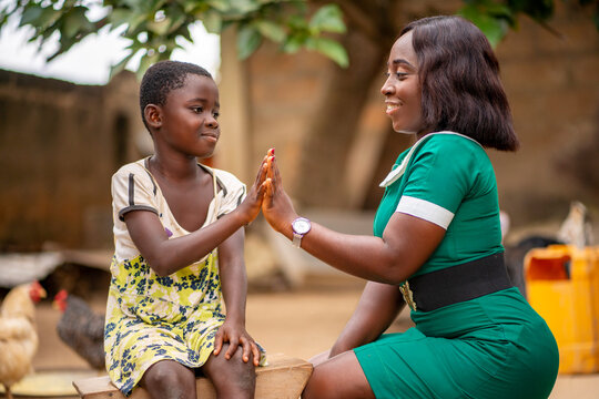 image of african kid and a health official with palm together- health concept