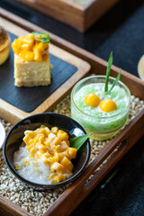 Many kinds of sweets made from mango, sweet thai dessert cuisine made from sticky rice, mango, coconut, Sliced mango with sweet and salty sauce that made of tiny shrimp with fish sauce and sugar, 