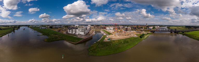 Fototapeta na wymiar 180 degrees aerial panoramic view on recreational port and Kade Zuid construction site of the new Noorderhaven neighbourhood along the river IJssel in Zutphen, The Netherlands