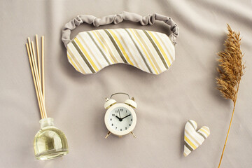 Healthy night sleep concept. Composition with eye sleeping mask, alarm clock, sleep aroma stick....