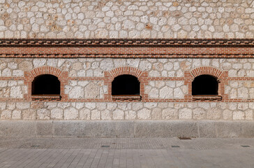 Detail of a brick wall with 3 windows