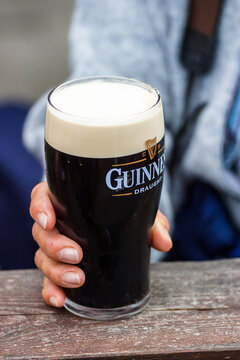 Woman Holding A Pint With Guinness