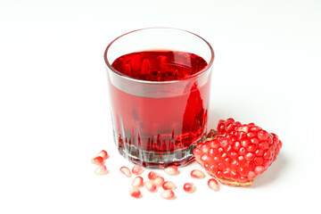 Glass of pomegranate juice and ingredient on white background