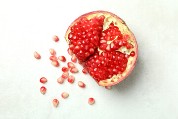 Ripe pomegranate on white textured background, close up