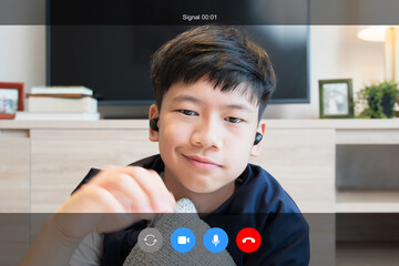 Webcam video call interface of portrait young handsome Asian teenager boy with wireless earbuds, smile to friends in live stream online learning class. Covid-19 New normal on education, communication