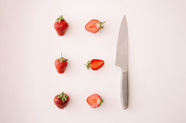 Fresh red strawberry fruit, leaf and knife on white background. Top view square, flat lay.