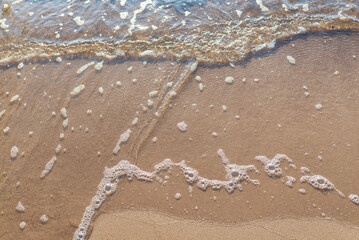 Soft wave of the sea on the sandy beach.Soft focus,blurred image.