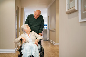 Senior man visit disabled woman on wheelchair at nursing home
