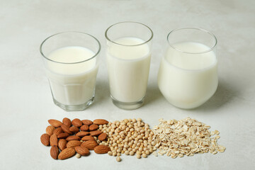 Concept of vegan milk on white textured background