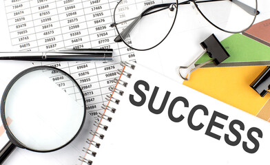 SUCCESS - the inscription of text on the Notepad, and chart. Business concept