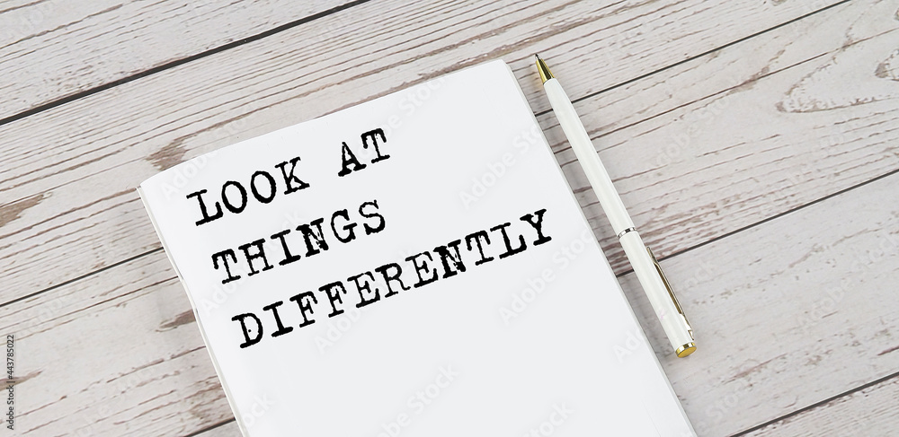 Aufkleber notepad with text look at thing differently . white background. business concept