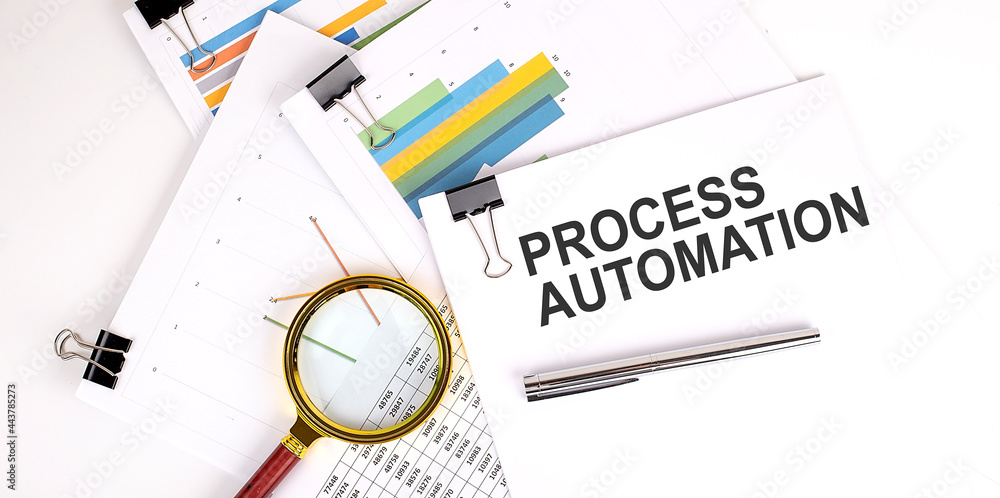 Aufkleber process automation text on white paper on light background with charts paper