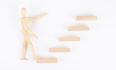 Wooden men walking up stairs ,to career ledder