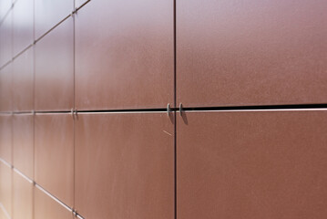 Background texture of rectangular smooth brown tiles. Stone street covering of wall, masonry of...