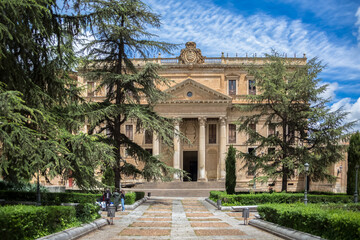Fototapeta na wymiar Front facade view at the Faculty of Philology at the University of Salamanca and park and garden surround