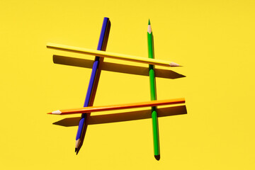 Colorful pencils on yellow background. Creative template, back to school concept. Pattern
