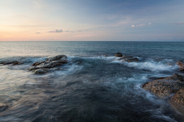 Fototapeta na wymiar Waves and rocks shore long exposure