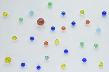 Colorful glass marbles on white background.