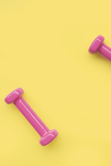 close up of dumbbell on yellow background
