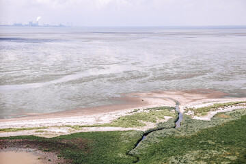 View from above on the dike and the Wadden Sea. Wadden Sea at low tide in the Netherlands or Germany 