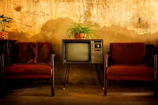 Vintage television, Antique TV, Retro technology, Old TV and old red sofa in room