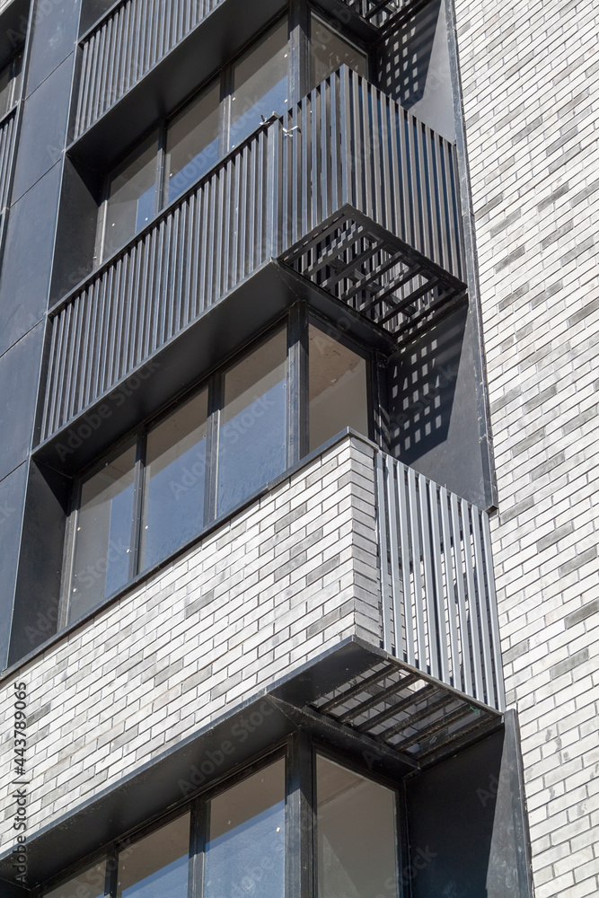 Poster facade of new high-rise building with windows and compartments for external blocks of split systems.