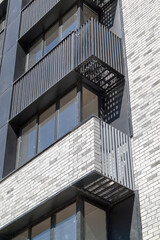 Fototapeta premium facade of new high-rise building with windows and compartments for external blocks of split systems. Fastening outdoor units of air conditioners