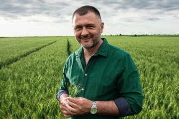 Portrait of farmer standing in wheat field. © Zoran Zeremski