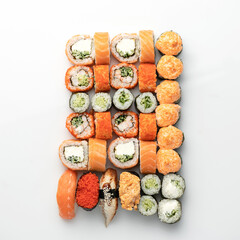 Big mixed Sushi and Sashimi Set, rolls isolated on white background. Classic Japanese food. Healthy Oriental meal. Wellness concept. Flat lay. Top view. Copy space.