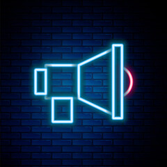 Glowing neon line Megaphone icon isolated on brick wall background. Speaker sign. Colorful outline concept. Vector