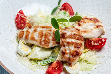 Caesar Salad with grilled chicken breast fillet and parmesan Cheese. Food recipe background. Close up