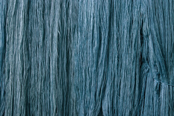 detail of texture of traditional Indigo blue natural dyed thread desiccate drying indoor