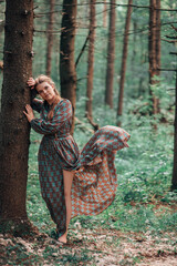 A girl in the forest with feathers