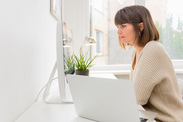 Young woman working as freelancer with laptop