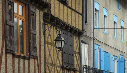 Fototapeta na wymiar old street lamp on colorful buildings, Le Mas d'Azil, France