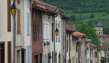 Fototapeta na wymiar old street lamps on colorful buildings, Le Mas d'Azil, France