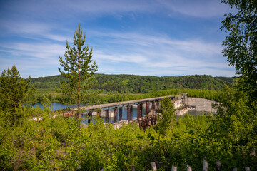 Fototapeta na wymiar View of abandoned hydroelectric power plant on the Taidon River in Siberia, Russia